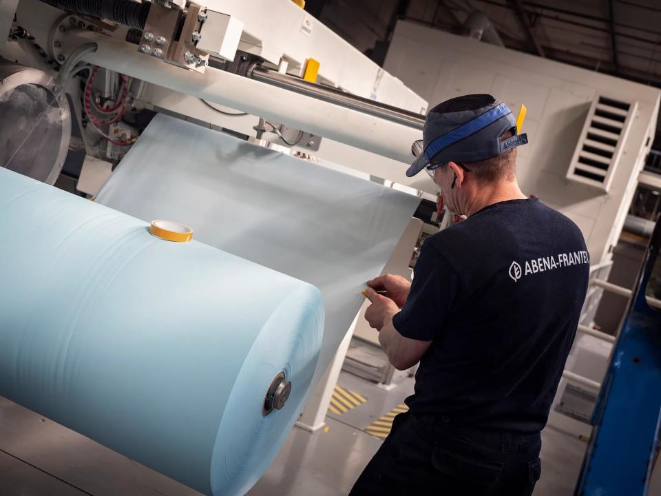 Produktionsmedarbejder, der står ved en maskine